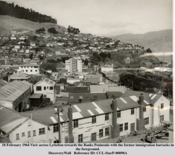 1964 View across Lyttelton towards the Banks Peninsula with the former immigration barracks in the foreground.