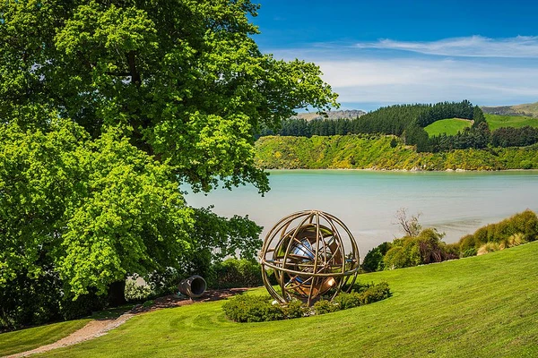 spherical sculpture at Ohinetahi garden looking out into Lyttelton harbour