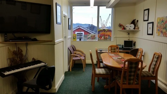 dining table, tv and keyboard at community house Lyttelton