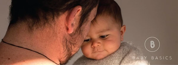 man holding baby photograph for baby basics