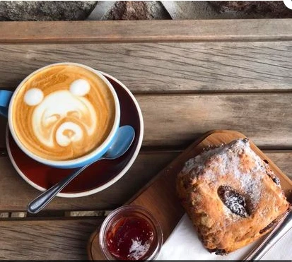 Sign of the Kiwi coffee, scone, jam and cream